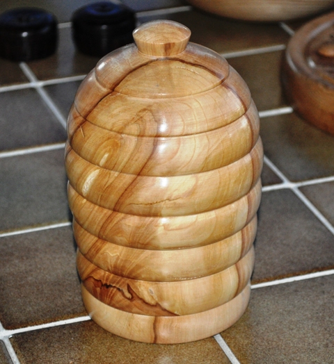 Turned wooden honey pot.